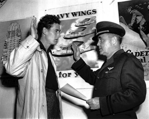 Historic photo of a young man swearing an oath to a naval officer at Bunker Hill Naval Air Station.