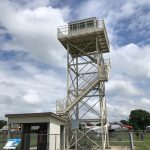 A picture from the ground of a Grissom AFB guard tower. Also shows the entry shed and interpretation sign.