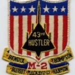 Patch with a stars and stripe shield background overlaid with the outline of the B-58 Hustler and listing the five trophies the 43rd Wing won.
