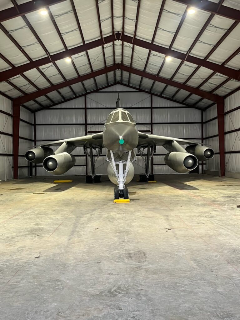 A front view of the B-58 inside the Cervantes Building at night with the lights on.