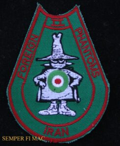 A horseshoe shaped patch in olive green with the words "Foreign II Phantoms Iran" with a white Spooky with a green, white, and red target on stomach.